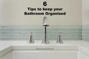 A bathroom sink with chrome fixture, shown against pale blue subway tile.