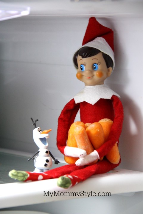 Elf on the shelf hoarding carrots in the fridge with Olaf