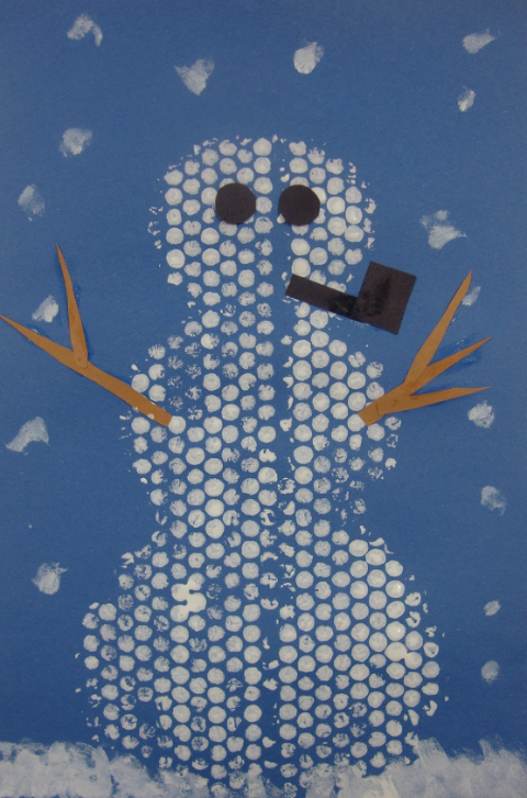 Bubble Wrap Art of a snowman on blue construction paper. 