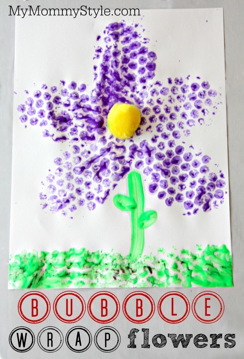 Bubble wrap art flowers with purple pedals and green grass. 