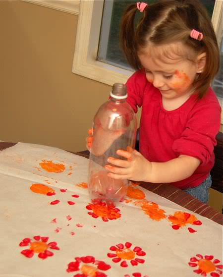 recycled art project of flowers made with bottom of 2L bottle. 