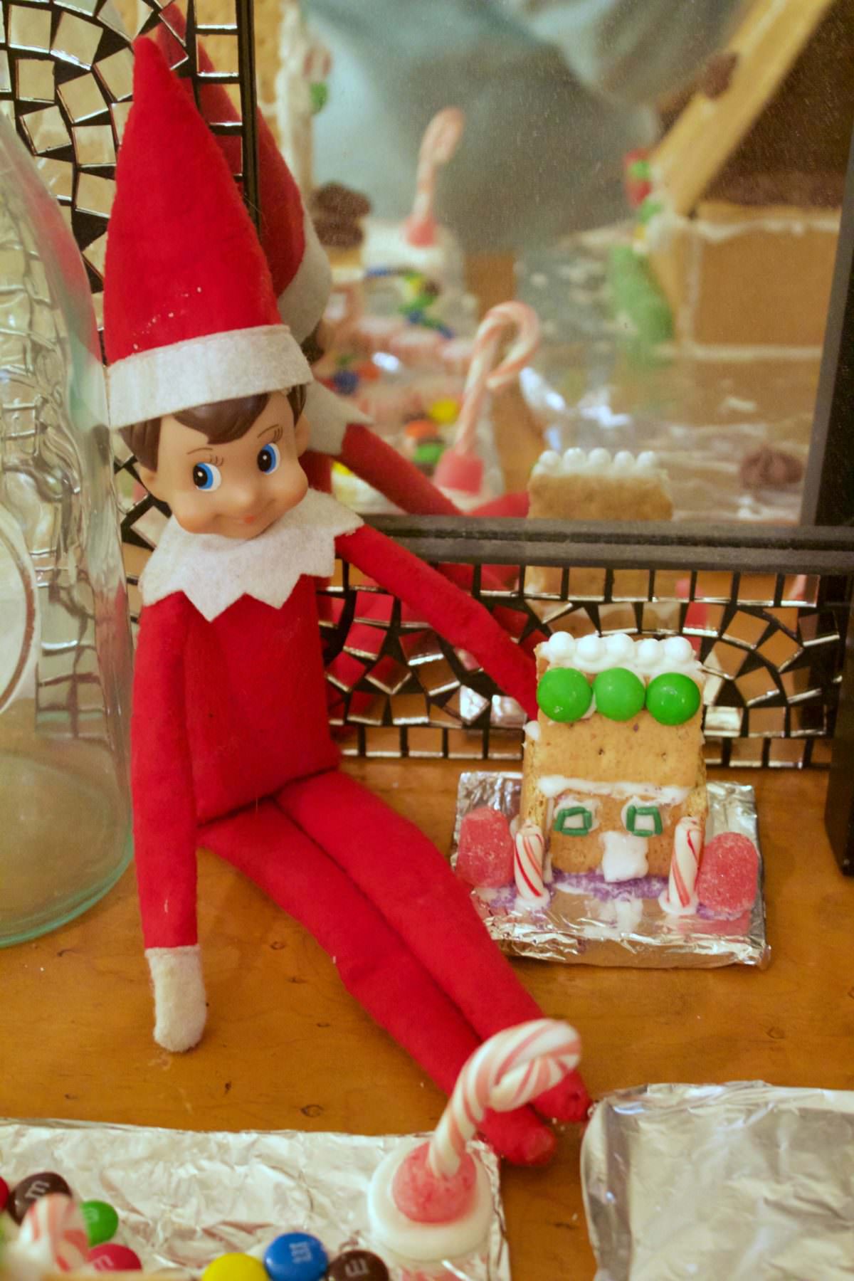 Elf on the shelf with a Gingerbread house