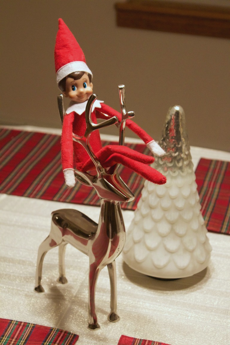 Elf on the Shelf riding a Reindeer