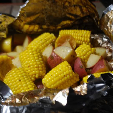 Foil dinner of corn and red potatoes made on the big green egg