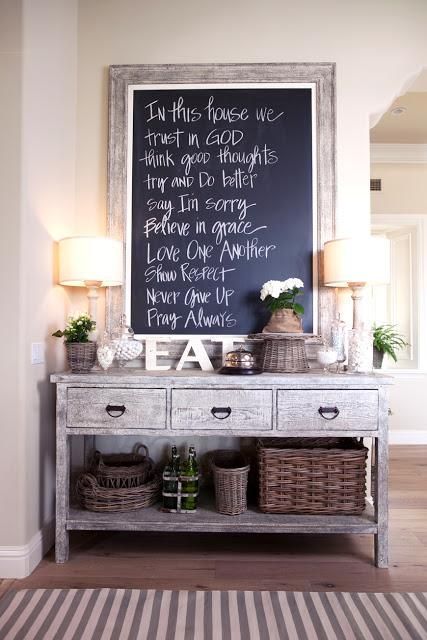 Rustic entrance table with large chalkboard above. 