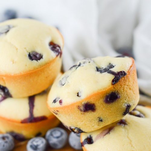 Gluten free blueberry muffins stacked.