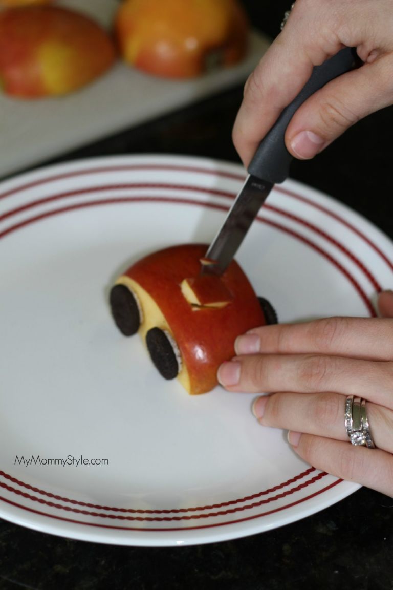 cutting out square in the apple with a knife. 