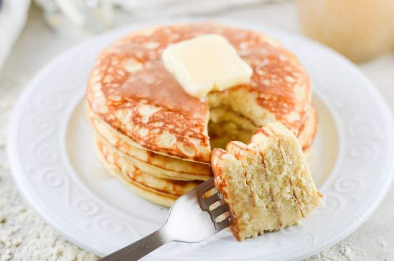 Stacked Keto Coconut Flour Pancakes with butter and syrup